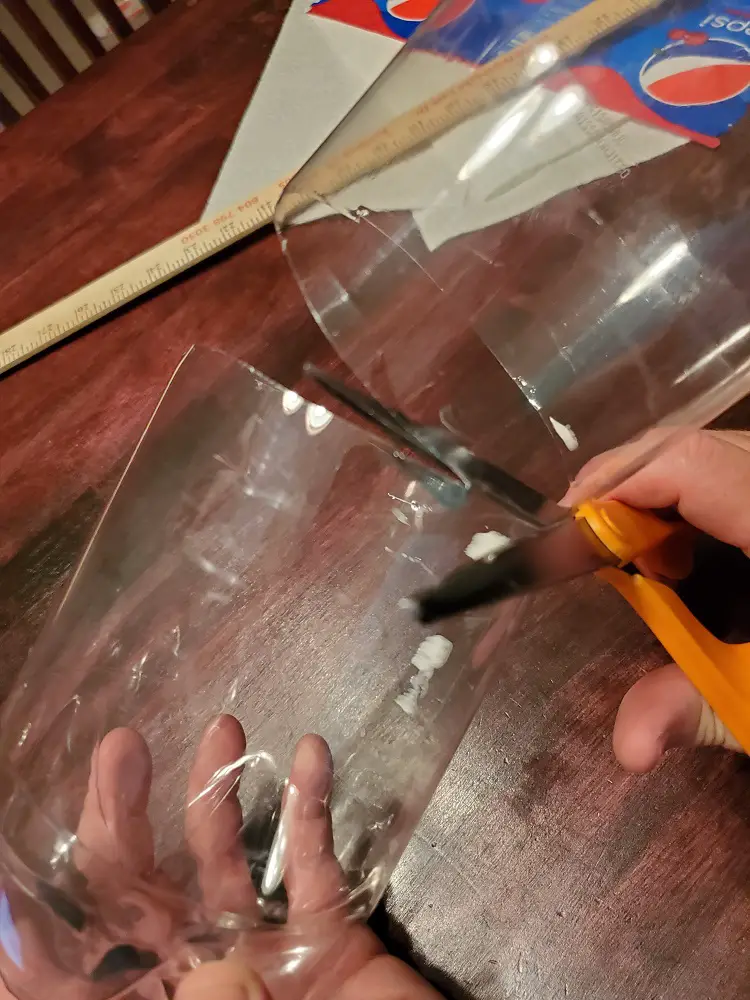 Cutting the bottle in half.