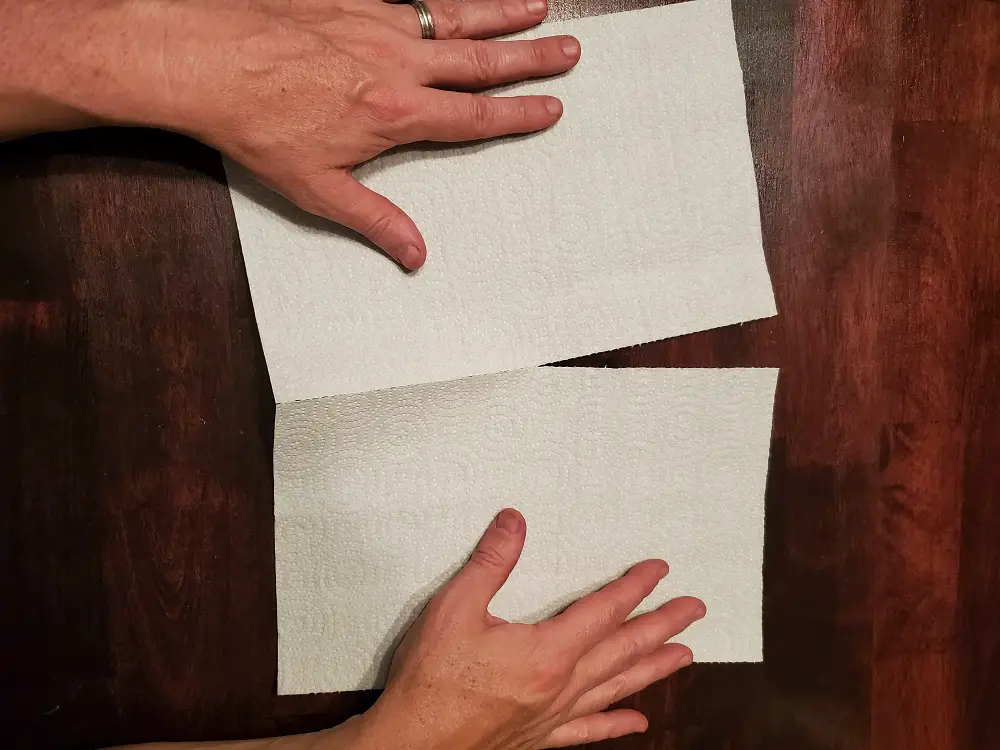 Tearing a paper towel in half.