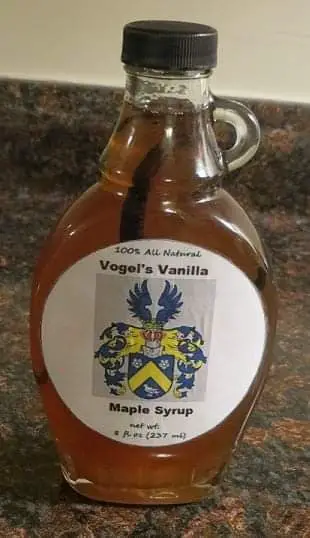 Homemade maple syrup in glass container.